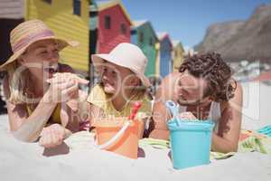 Happy family lying together on blanket at beach