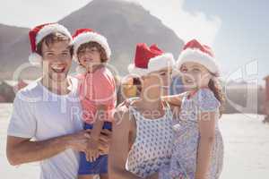Smiling family wearing Santa hat