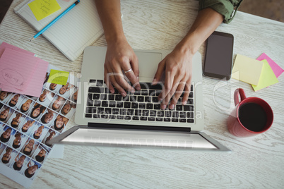 Hands of female photo editor using laptop in office