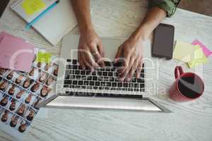 Hands of female photo editor using laptop in office