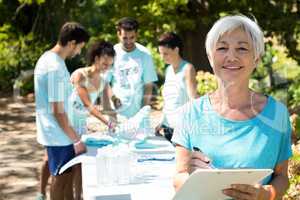 Coach smiling while athletes registering for marathon