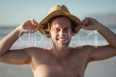 Portrait of smiling shirtless man wearing hat