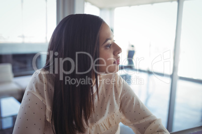 Thoughtful businesswoman looking away in office