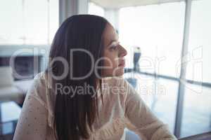 Thoughtful businesswoman looking away in office