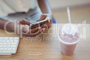 Executive using mobile phone at desk