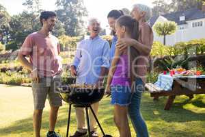 Family preparing barbecue in the park