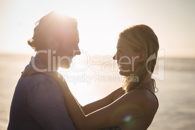 Happy young couple embracing at beach