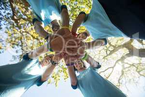 Volunteers forming a hand stack in the park