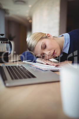Tried executive sleeping at desk
