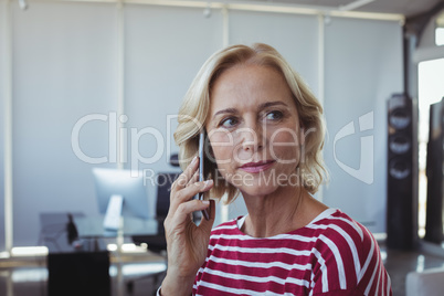 Entrepreneur looking away while talking on mobile phone