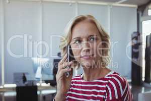 Entrepreneur looking away while talking on mobile phone