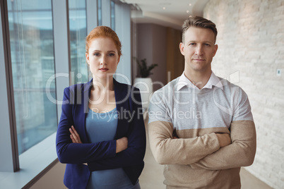 Portrait of executives standing with arms crossed