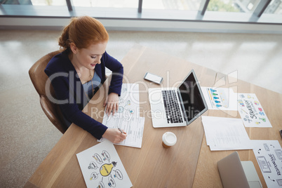 Overhead view of attentive executive working at desk