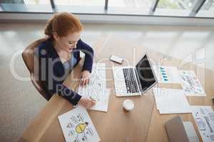 Overhead view of attentive executive working at desk