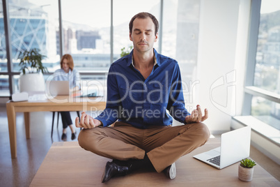 Executive meditating on desk