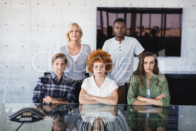 Portrait of confident colleagues at desk