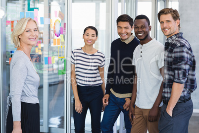 Portrait of business people standing by plan