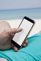 Close up of man using mobile phone at beach
