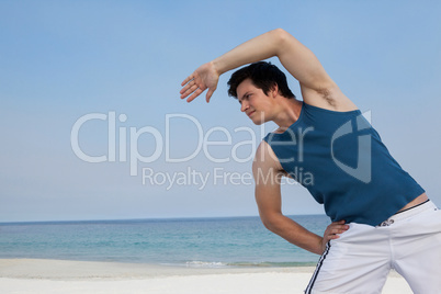 Man doing warm up on beach
