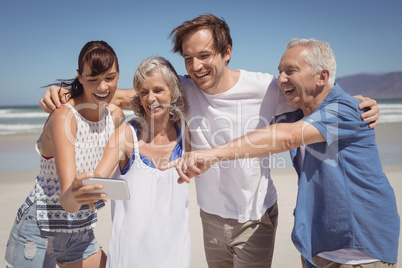 Cheerful family looking at mobile phone