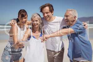 Cheerful family looking at mobile phone