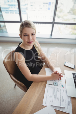 Portrait of smiling executive working at desk