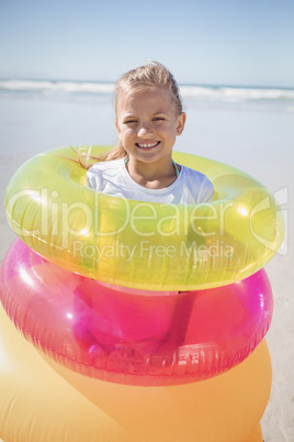 Portrait of girl standing in inflatable rings