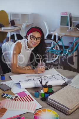Portrait of smiling businesswoman working in creative office