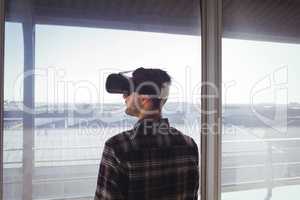 Businessman wearing virtual reality headset in office