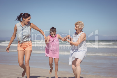 Happy multi-generation family playing at beach