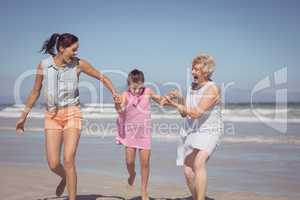 Happy multi-generation family playing at beach