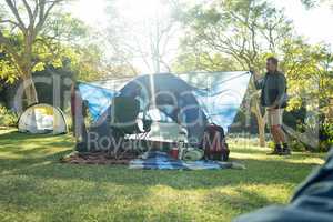 Father and son setting up a tent