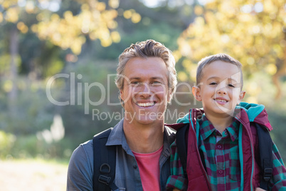 Portrait of father and son in forest