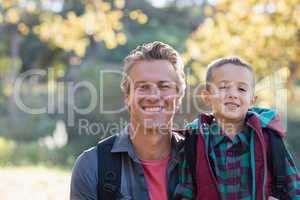 Portrait of father and son in forest