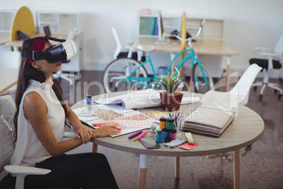 Businesswoman using virtual reality technology in creative office