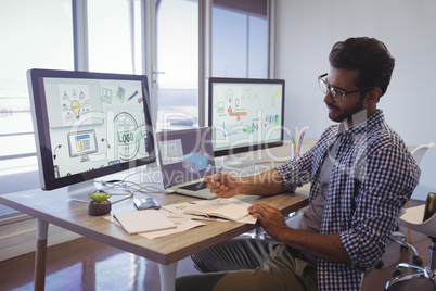 Thoughtful young businessman working at office