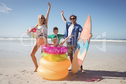 Cheerful family with arms raised at beach