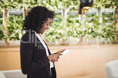 Smiling businesswoman using digital tablet