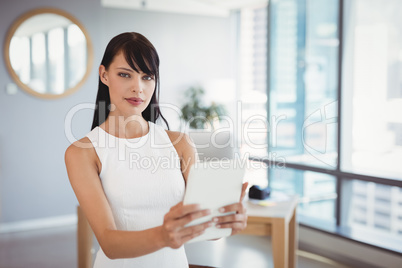 Portrait of beautiful executive using digital tablet