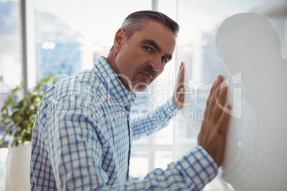 Portrait of sad executive leaning on wall