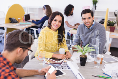 Portrait of business people at desk