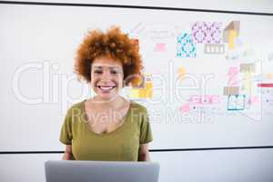Portrait of smiling businesswoman with laptop