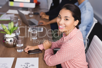 Portrait of businesswoman sitting at desk