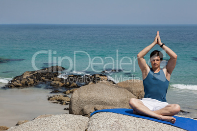 Full length of man meditating at beach
