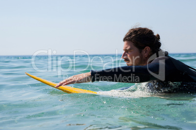 Surfer surfboarding in the sea