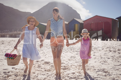 Portrait of multi-generated family walking at beach