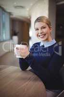 Portrait of smiling executive having coffee