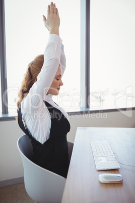 Executive exercising at desk