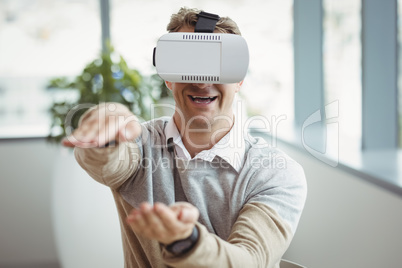 Happy executive using virtual reality headset
