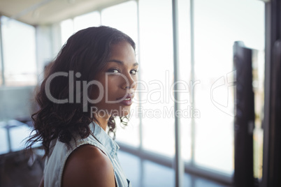 Confident businesswoman standing in office